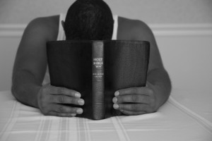 man praying with bible